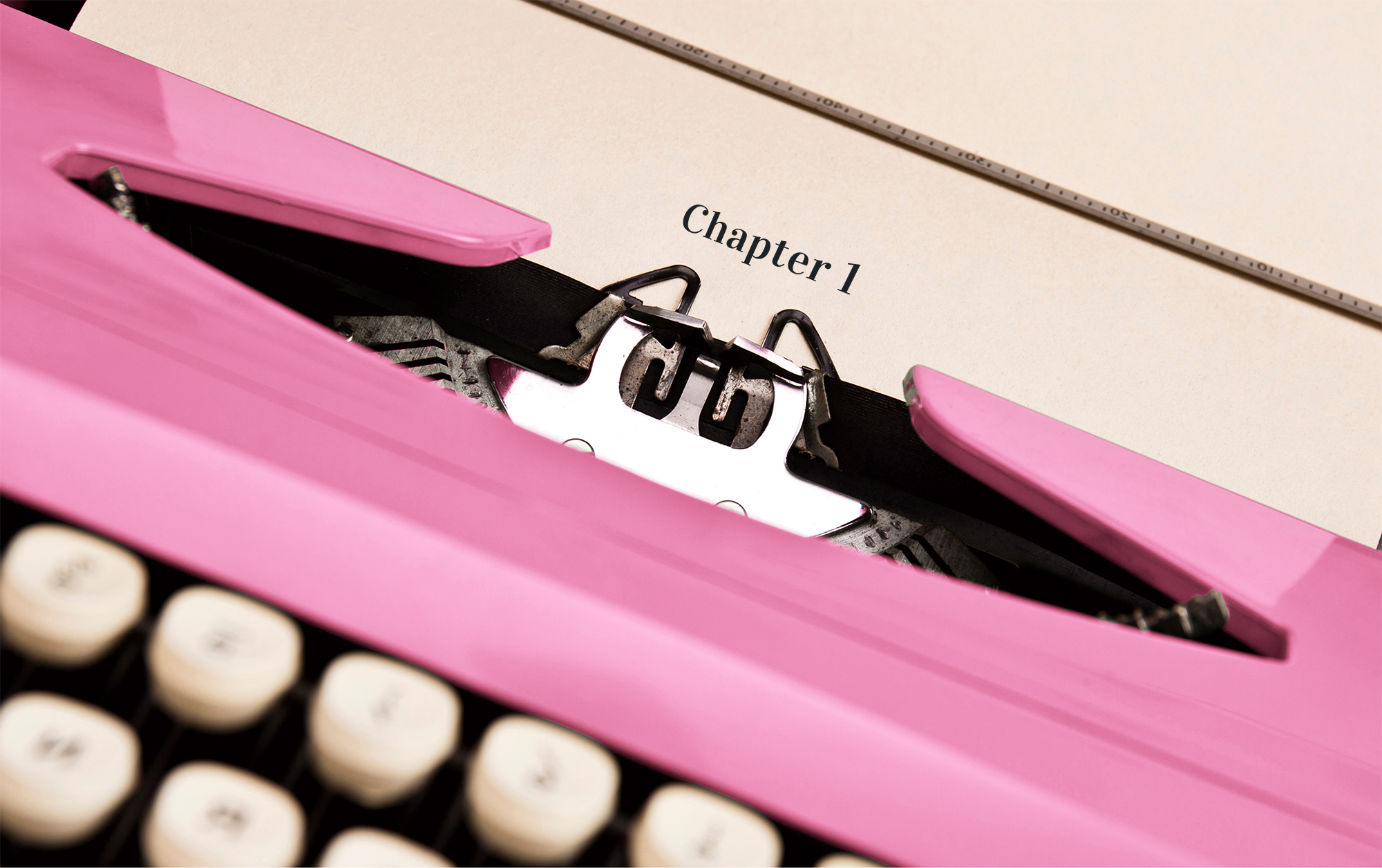A pink typewriter typing out the words, "Chapter 1"