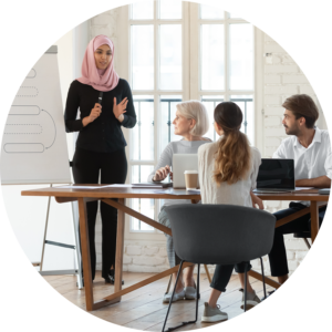 A strong, confident woman giving a speech in front of her attentive colleagues.