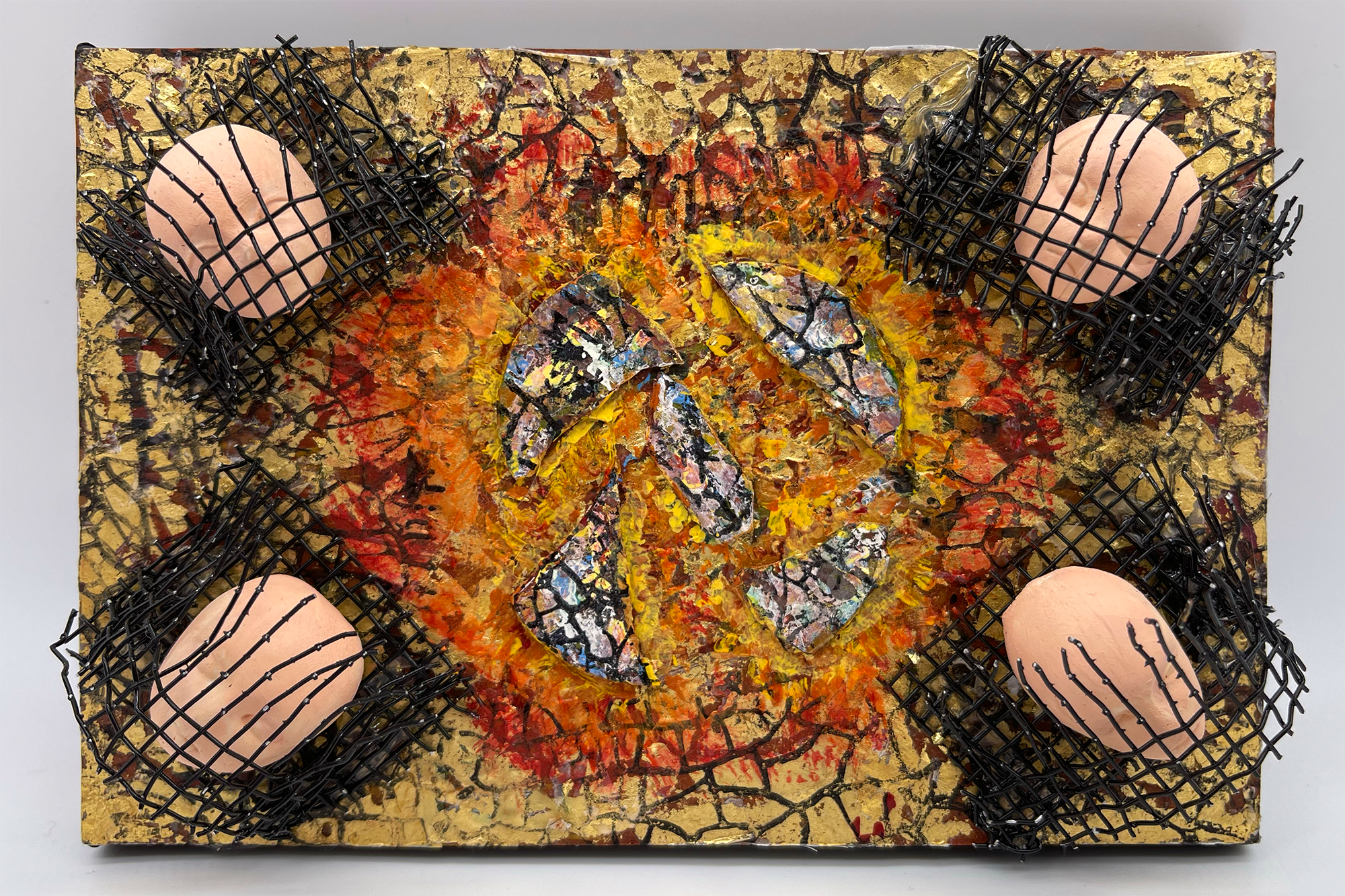 A mixed media 3D sculptural painting by A.H. Lawver entitled, "Ukraine." There's a metaphorical explosion in the center in reds & oranges, with four sculpted heads trapped behind wire in each corner. 